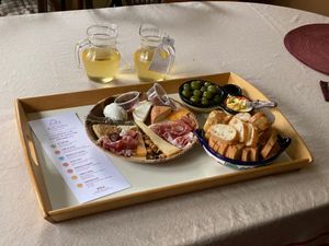 A cheese plate with wine and bread