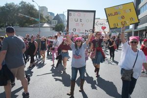 Two protesters holding signs. One reads: Stay Out of My Vagina. Another reads: We must not be silent.