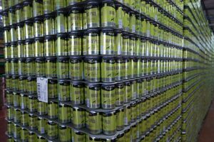 A stack of Hans Pils beer cans.